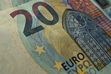 Close-up fragment of the 20 euro banknote with small blue details. High quality photo