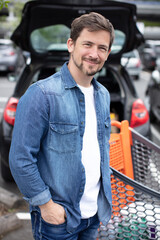 young man with mask holding shopping cart