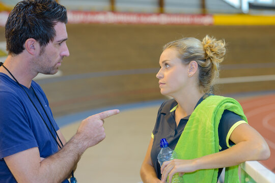 a coach reprimanding sports woman