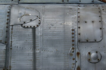 A fragment of the fuselage of an old fighter, background.
