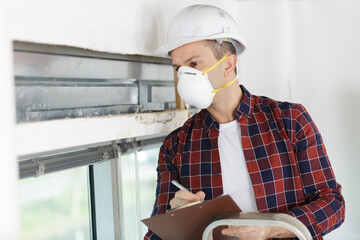 man wearing mask supervising a construction problem