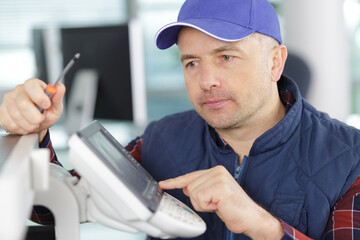 hardware repairman repairing broken printer