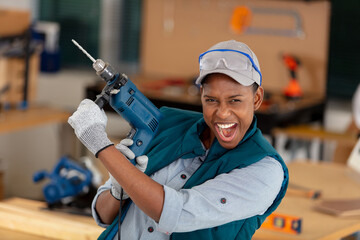 happy cheerful woman holding a drill