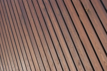 A wall of light brown wooden boards. Background from wooden boards.