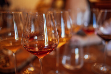 Glass goblets placed in rows on table during wine tasting procedure in restaurant
