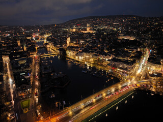 Fototapeta na wymiar Aerial view of Swiss City of Zürich with cityscape, skyline, city lights, Limmat River and Lake Zürich on a dark winter night. Photo taken January 5th, 2024, Zurich, Switzerland.