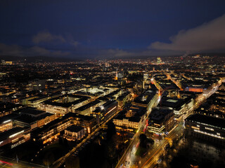 Aerial view of Swiss City of Zürich with cityscape, skyline and city lights on a dark winter night. Photo taken January 5th, 2024, Zurich, Switzerland.