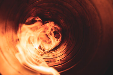 combustion system in an open supply fire in a spiral-wound air duct, front and back background...