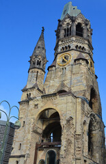 Fototapeta na wymiar The Kaiser Wilhelm Memorial Church is one of Berlin's most famous landmarks. The damaged tower is a symbol of Berlin's resolve to rebuild the city. Berlin Germany
