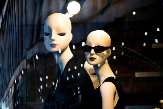 Belgrade, Serbia - July 11, 2018: Female mannequin doll displayed n the Max Mara shop window with city reflections