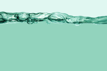Green splashing cosmetic moisturizer, micellar water, toner, or emulsion abstract background....