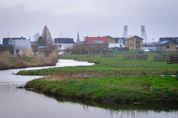 Fototapeta na wymiar Idyllic view of the Dutch watery polder landscape with the village of Boskoop in the distance