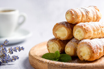 Delicious puff pastry tubes filled with custard