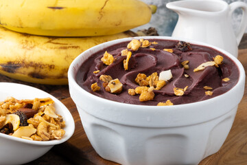 Brazilian açaí with granola in a bowl. Selective focus.