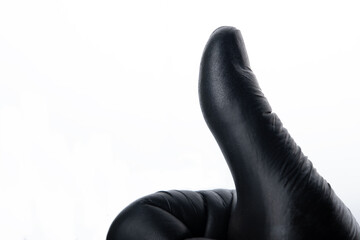 Thumbs up using black glove isolated on white background. Positive concept.