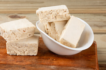Mini square of nougats on cutting board.