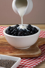 Blueberries in a bowl with yogurt. Selective focus.