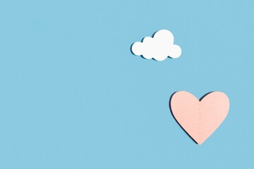 Wooden heart on a pastel blue background. Concept for Valentine's Day, World Women's Day, Mother's Day. Romantic flat composition.