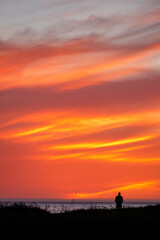 Silohuette of a single person watching the sunset over the Pacific Ocean, Santa Barbara, California