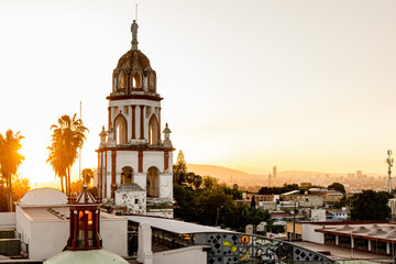 Sunset over the steeple of Parroquia San Pedro Apóstol Catholic church in the heart of...