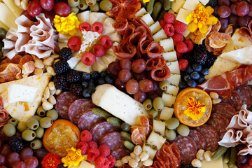 A close up of a highly stylized charcuterie board