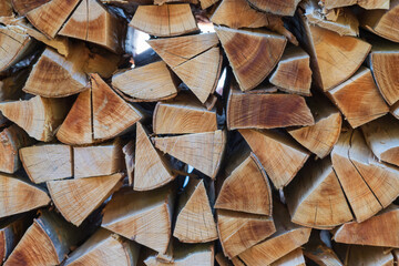 Cut wood by the meter is stacked and ready for heating for the winter. - obrazy, fototapety, plakaty