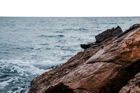 Winter sea with stones on the beach on transparent background. Underwater rock. Mediterranean sea.