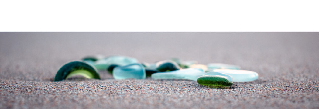 Mediterranean sea beach and colorful stones on transparent background. Glass stones from broken bottles