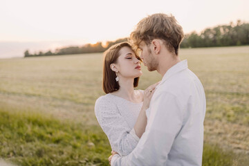 couple in love on a date in nature hugging in a white outfit in the summer. Love, happiness of a...