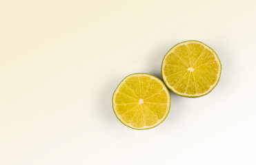 Halves or slices of green lime on light white background. Fresh fruits with copy space for text