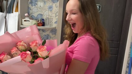 international congratulations agency flower delivery young girl opens the door meets the messenger with a bouquet birthday joy happiness roses pink home furnishings Ukraine. Vinnitsa
