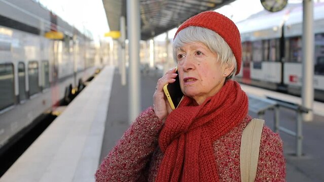 Senior female traveler getting bad news at train station 