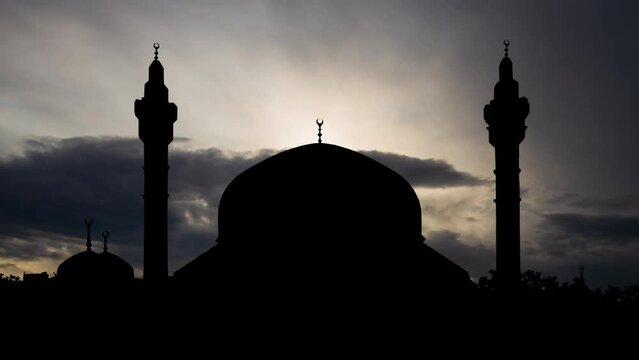 Abdullah King Mosque: Time Lapse at Sunrise with Fast Clouds and dark silhouette of Dome and Minaret, Amman, Jordan