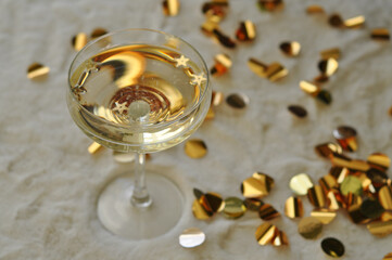 glass of champagne with gold confetti