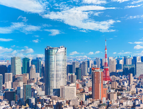 An expansive view capturing a jungle of buildings overseeing the cityscape of Roppongi and Hamamatsucho featuring the striking Roppongi Hills and Tokyo Tower, two landmarks skyscrapers of modern Japan