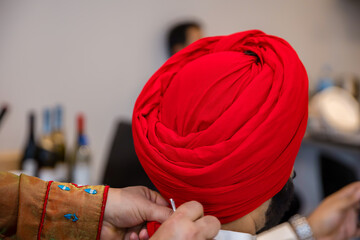 Indian Punjabi Sikh groom red wedding turban close up