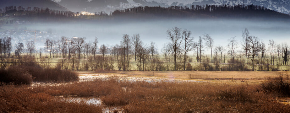 landscape in the mountains, winter morning time and fog in the background