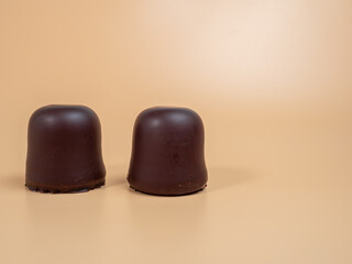 Marshmallows in chocolate glaze on an orange background. Marshmallow close-up.