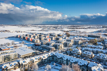 Aerial landscape of the road through snowy Rotmanka village at winter, Poland. - obrazy, fototapety, plakaty