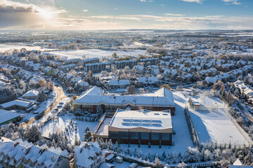 Aerial landscape of the road through snowy Rotmanka village at winter, Poland. - obrazy, fototapety, plakaty
