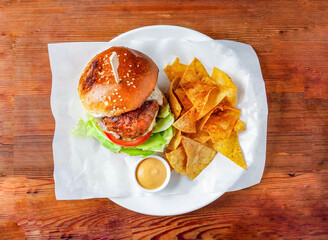 tandoori pork burger with cabbage, mayonnaise dip and crackers served in dish isolated on wooden table top view of hong kong food
