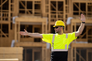 Building concept. Builder foreman. Caucasian man construction worker in helmet at construction site. Concept of construction building. Construction site manager. Worker in helmet on building.