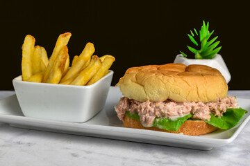 tuna salad on a bulkie roll with french fries