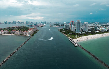 Naklejka premium Fisher Island skyline with buildings seen from bay in South Beach. Miami Beach and Fisher Island aerial view. Luxury apartments on Fisher Island. Fisher Island from South Point Park Miami.