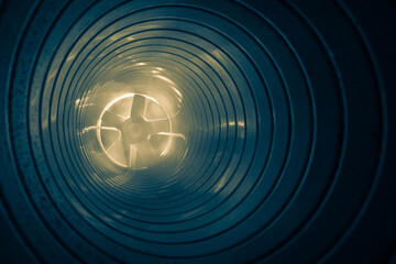 smoke in the ventilation duct of the air system of a shopping center, on a blurred background of...