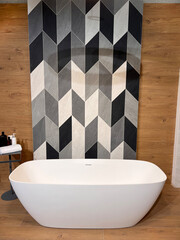 Modern ceramic bathtub . White tub in minimalistic bathroom interior. Porcelain bathtub with...
