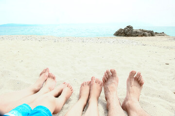 Fototapeta na wymiar beautiful legs in the sand of the sea greece background