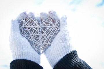 A Heart in the hands of a girl against the sky Valentine's day in a park in nature