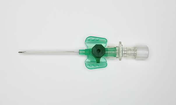 Closeup of one isolated safety IV catheter cannula needle with injection port on white background