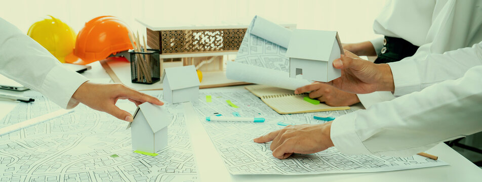 Worker, architect and engineer work on real estate construction project oratory planning with cartography and cadastral map of urban town area to guide to construction developer business plan of city